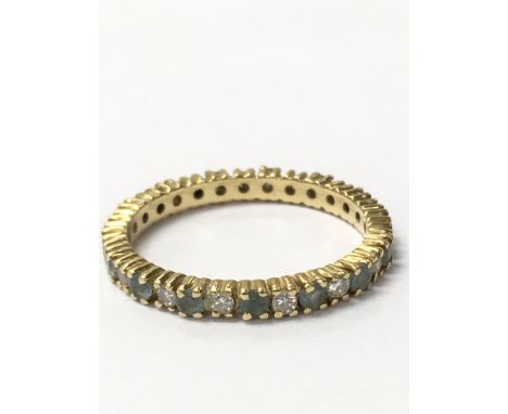 An unmarked eternity ring with alternating aquamarine and white stones. Weighing approximately 2.5g and measures approximatel