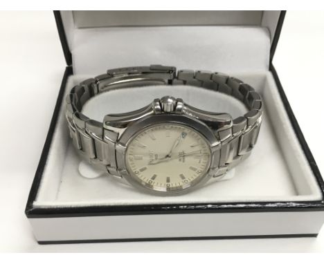 A Tissot watch with date aperture and baton numerals.