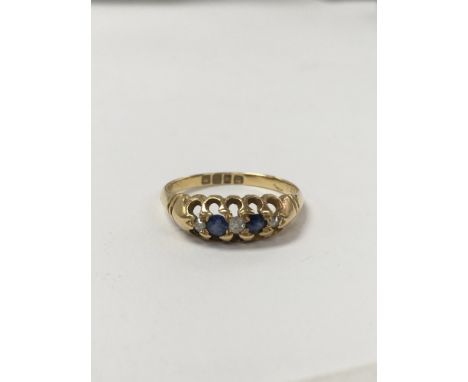 An 18 carat gold sapphire and diamond ring set with a single row of alternating diamonds. Measuring approximately ring size O