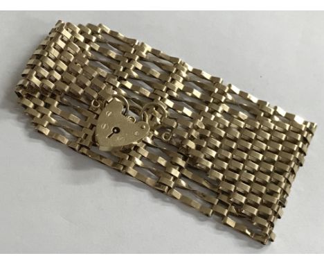 A gold gate bracelet with heart padlock. Weight 22g