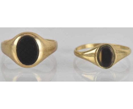 A 9ct yellow gold onyx set signet ring, size J, and a further 9ct yellow gold onyx set signet ring, size K, combined approx 3