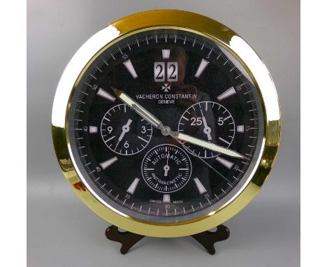 A decorative modern Vacheron Constantin style dealer's wall clock, the black dial set with subsidiary seconds, hour markers a