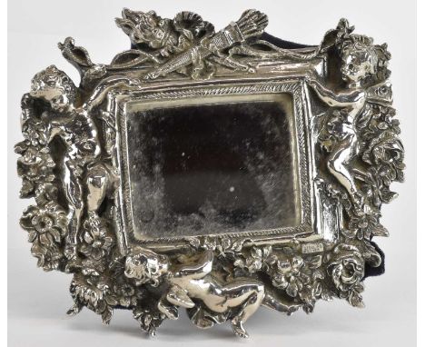 A sterling silver desktop rectangular mirror within a large heavily cast Classical theme depicting three putti, arrows, and f