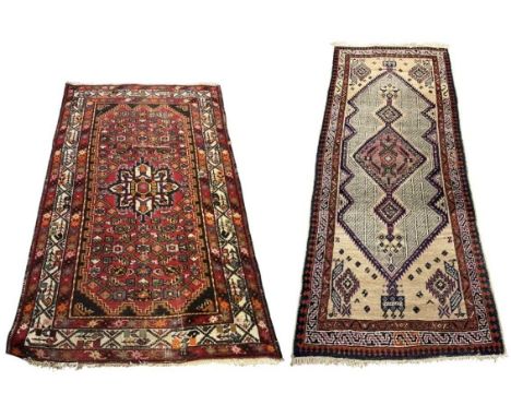 Two Persian hand knotted red ground geometric design carpets, 280 x 91cm and 160 x 100cm (2).