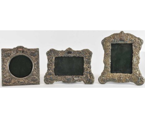 Three hallmarked silver Victorian picture frames of Classical design, all with winged cherubs, scrolls, flowers, and acanthus
