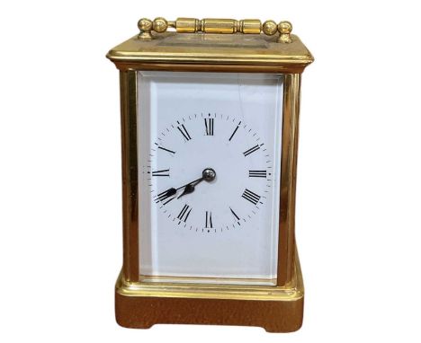 An early 20th century brass cased carriage clock, the white enamel dial set with Roman numerals and subsidiary seconds, heigh