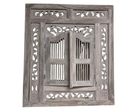 A modern limed oak rectangular wall mirror, with pair of grille doors enclosing mirror and with carved frame, 90 x 80cm.