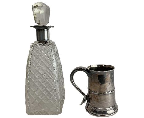 A large press moulded glass decanter, with crosshatched four square side body, with hallmarked silver rim, with four pouring 
