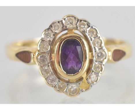 A 14ct yellow gold amethyst and diamond set cluster ring, the central amethyst approx 0.5ct, surrounded by multiple small rou