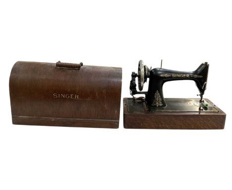 An early 20th century oak cased Singer sewing machine.