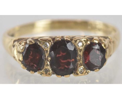 A 9ct gold dress ring, set with three graduated cut garnets, size P, approx 2.7g.
