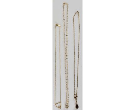 Three 9ct gold necklaces, comprising an example with Playboy style bunny and open heart pendant, on dainty chain, length 40cm