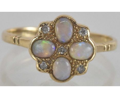 A 9ct gold opal and diamond set ring, the flower form head with four small oval opals at each quarter with a small diamond ch