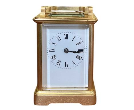 An early 20th century gilt bronze cased carriage clock, the white enamel dial set with Roman numerals and subsidiary seconds,