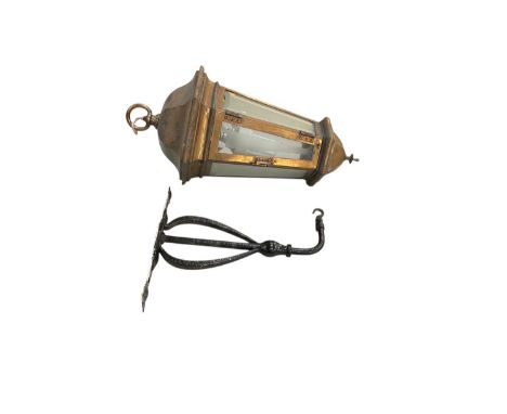 A modern hexagonal ceiling hanging lantern, with black painted Arts and Crafts style bracket, height of lantern 65cm.