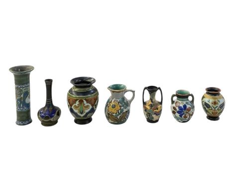 GOUDA POTTERY; seven pieces of assorted Dutch art pottery, including a tall trumpet type vase, height 19.5cm, two twin handle