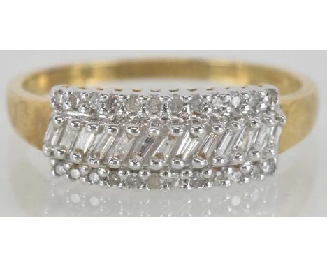A 9ct gold dress ring, with a central line of small baguette cut diamonds with an upper and lower border of tiny brilliant cu