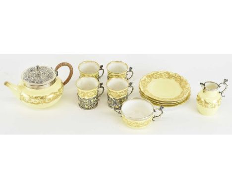 ROYAL WORCESTER; a late Victorian hallmarked silver mounted four setting coffee service, comprising four silver mounted coffe