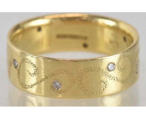 An 18ct gold band ring, with offset tiny diamond chips, size L, approx 5g.