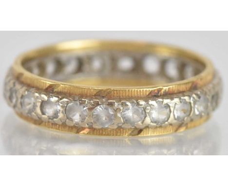 An 18ct yellow and white gold diamond set eternity ring, size N, approx 3.7g.
