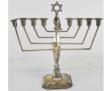 ALBERT SYDENHAM; an Elizabeth II hallmarked silver menorah candlestick, decorated with Star of David to the top, Birmingham 1