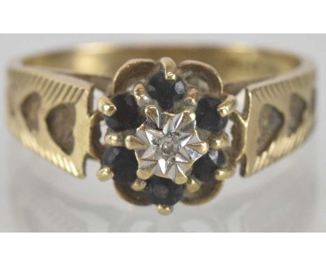 A 9ct gold sapphire and diamond ring, the illusion star set diamond chip within a border of six claw set small sapphires on h