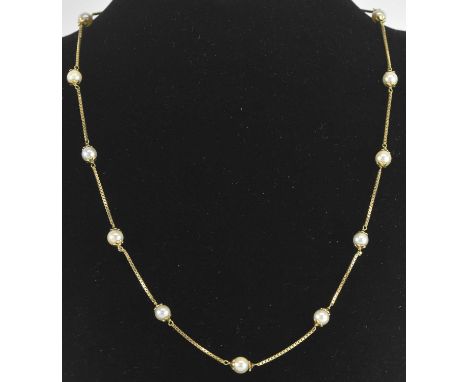 An 18ct yellow gold seed pearl set fine link necklace, set with fourteen seed pearls, length approx 50cm, approx 11.5g.