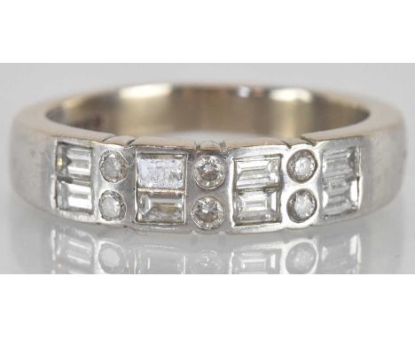 An 18ct white gold diamond set ring, set with six small round brilliant cut diamonds and eight small baguette cut diamonds, s