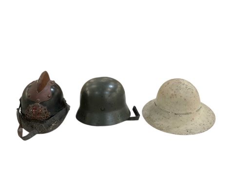 A German WWII Third Reich SS military helmet, a white painted English WWII military helmet and a Czechoslovakian fireman's he