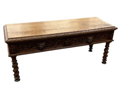 A Victorian carved oak low two drawer side table, on barley twist supports, width 122cm, depth 46cm, height 51.5cm.