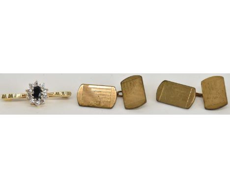 A 9ct yellow gold sapphire and diamond set cluster brooch, the central sapphire approx 0.5ct, surrounded by ten small round b