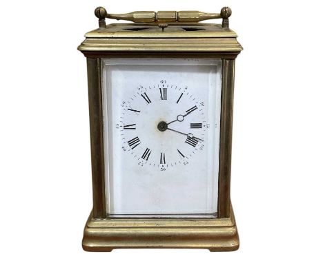 A large early 20th century brass cased strike repeating carriage clock, the white enamel dial set with Roman numerals, Arabic