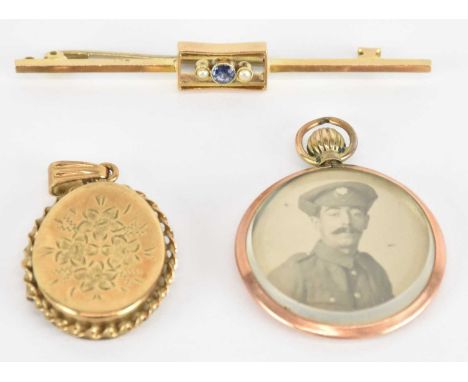 A 9ct yellow gold sapphire and seed pearl set bar brooch, length 5cm, a 9ct yellow gold oval locket pendant, with embossed fl