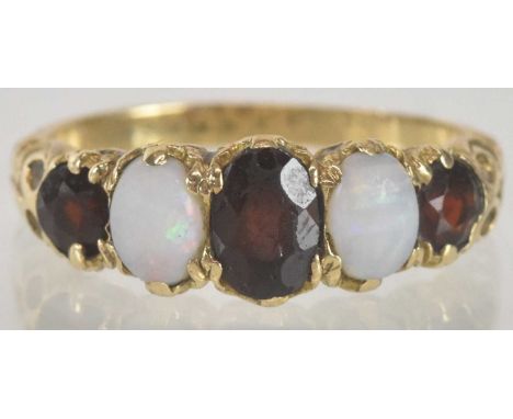 A 9ct gold dress ring set with three graduated garnets separated by two small opals, size M, approx 2.4g.
