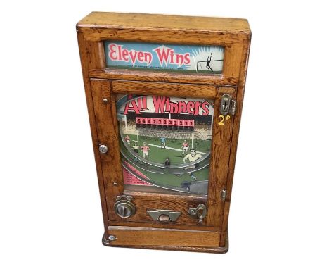 PARKERS AUTOMATIC SUPPLIES; a 1920s oak cased football penny-in-the-slot arcade machine, 'Eleven Wins', height 81cm, width 46