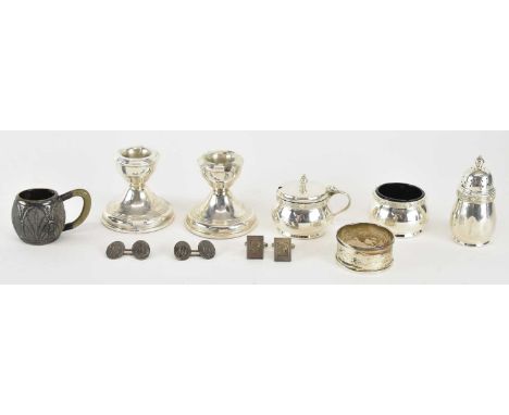 A group of small hallmarked silver items, comprising a pair of short loaded candlesticks, height 6cm, napkin ring, three piec