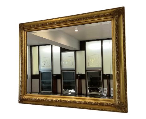 A large modern rectangular gilt framed bevelled glass wall mirror, 97 x 125cm.