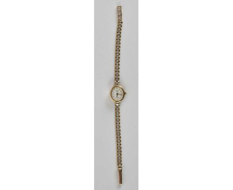 A lady's 9ct gold W. Croxton, England quartz wristwatch, the oval white dial set with raised baton markers, in a 9ct gold cas