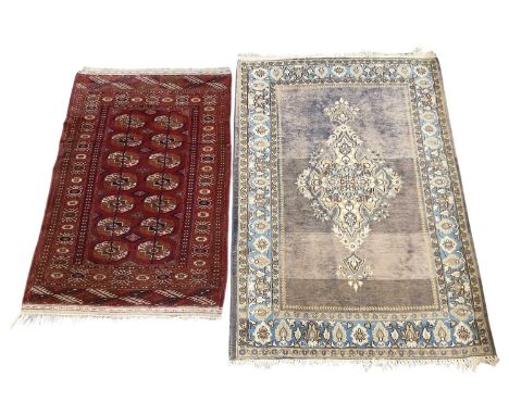 A Persian hand knotted red ground carpet, with geometric designs, 127 x 83cm, and a further hand knotted beige ground carpet,