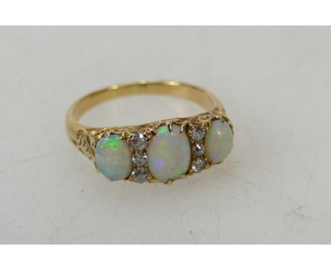 Opal &amp; diamond gold ring: 3 stone Opal &amp; 6 Diamond ladies dress ring.  Shank unhallmarked but tested as high carat go