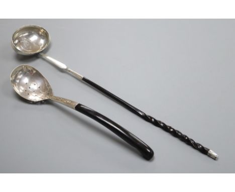 A 19th century white metal toddy ladle with inset coin bowl and a continental white metal server.