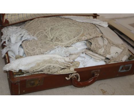 A large collection of hand worked crochet linens in a trunk