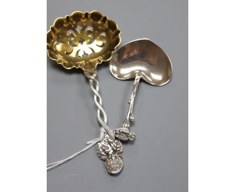 A Tiffany &amp; Co sterling silver heart-shaped caddy spoon and a Tiffany strawberry sifter spoon with oval pierced gilded bo