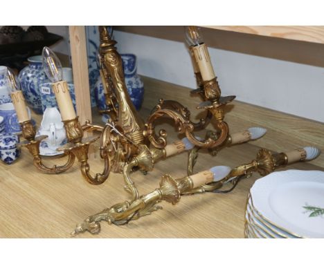 A brass five branch ceiling light and a pair of wall lights