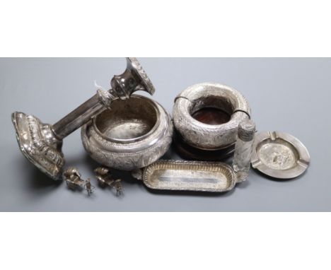 A Malayan white metal bowl, flower holders, two dishes and a silver candlestick.