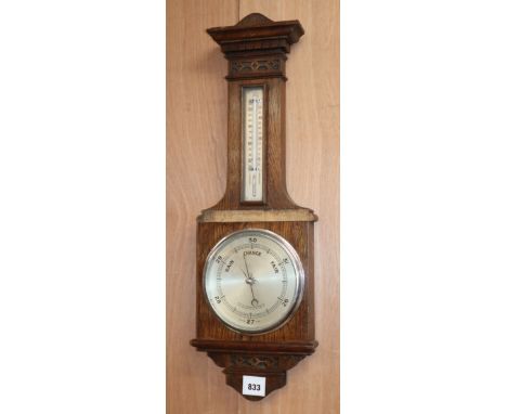 An early 20th century oak aneroid barometer and thermometer H.68cm