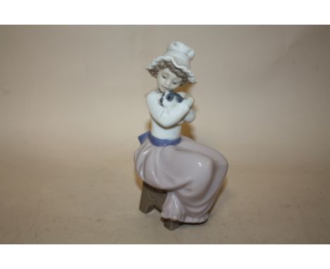 A NAO FIGURE OF A YOUNG GIRL HOLDING A PUPPY