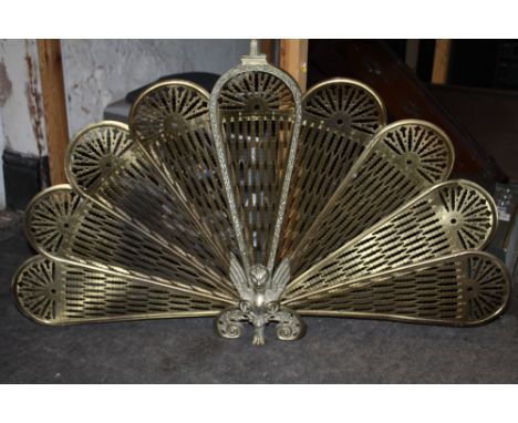 A VINTAGE BRASS PEACOCK FAN FIREGUARD
