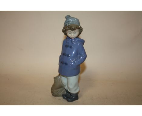 A NAO FIGURE OF A YOUNG BOY WITH A SATCHEL