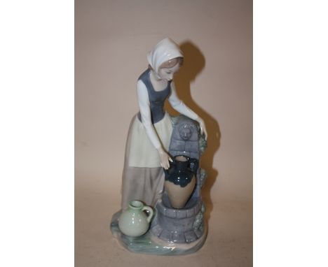 A NAO FIGURE OF A LADY COLLECTING WATER FROM THE FOUNTAIN